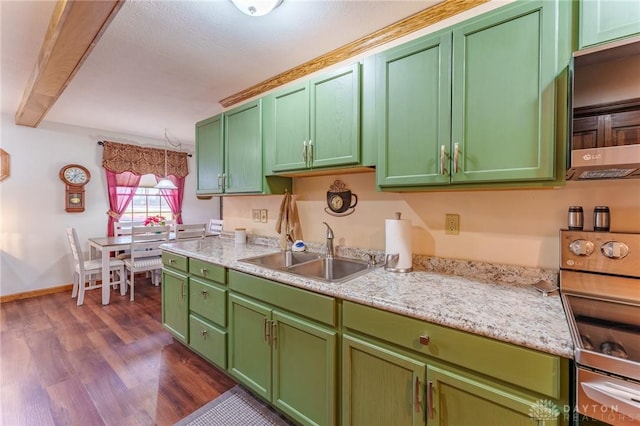 kitchen featuring stove, sink, green cabinets, and dark hardwood / wood-style flooring