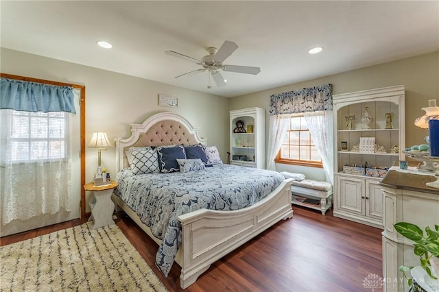 bedroom with ceiling fan and dark hardwood / wood-style floors