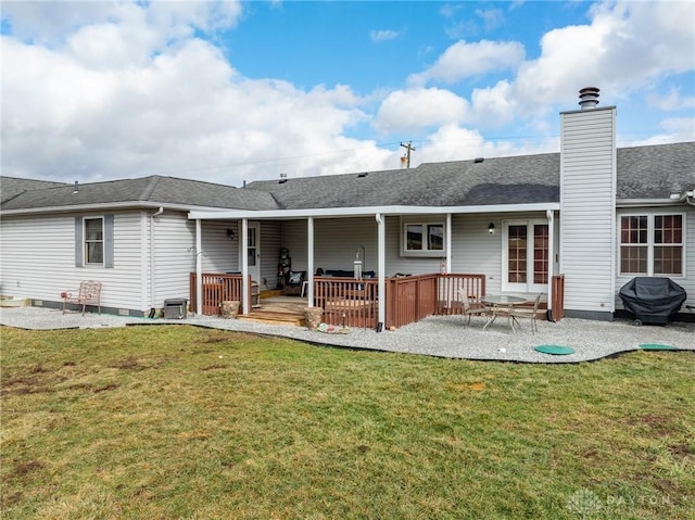 back of property with a wooden deck, a yard, central AC unit, and a patio area