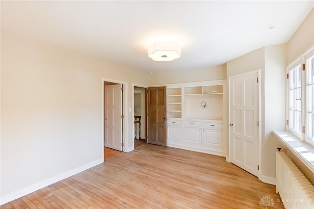 1515 Woodstock Dr, Oakwood, OH 45419 - unfurnished bedroom featuring radiator, light wood-style flooring, a closet, and baseboards