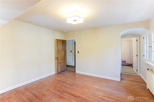 unfurnished room with light hardwood / wood-style floors