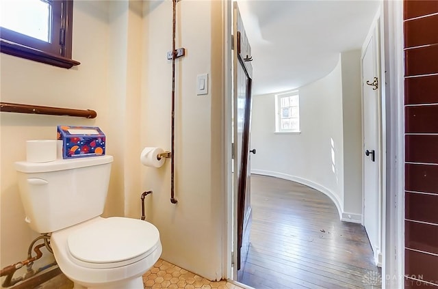 bathroom with wood-type flooring and toilet