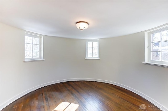 1515 Woodstock Dr, Oakwood, OH 45419 - empty room featuring plenty of natural light and dark wood finished floors