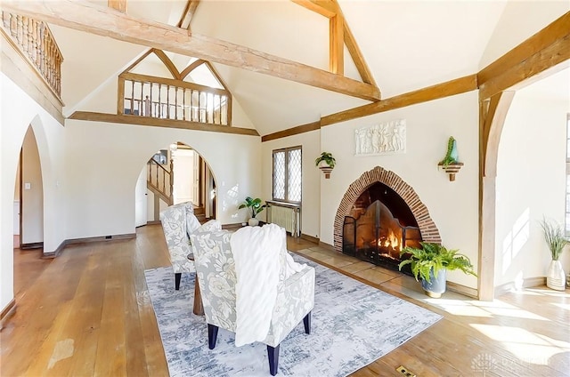 1515 Woodstock Dr, Oakwood, OH 45419 - living area with arched walkways, wood-type flooring, high vaulted ceiling, and stairway