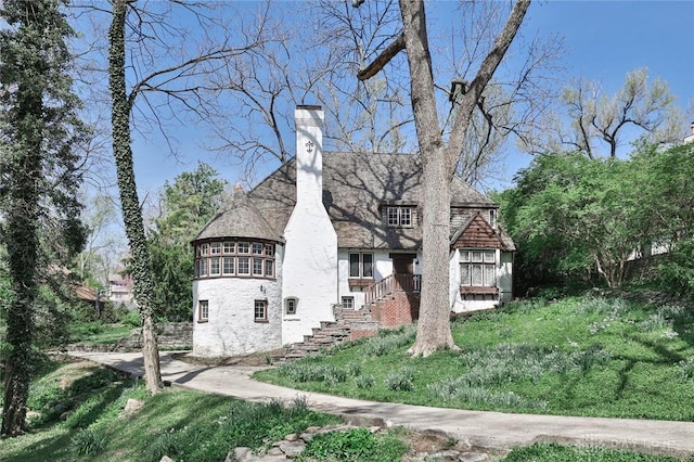 1515 Woodstock Dr, Oakwood, OH 45419 - tudor house featuring a chimney and stairs