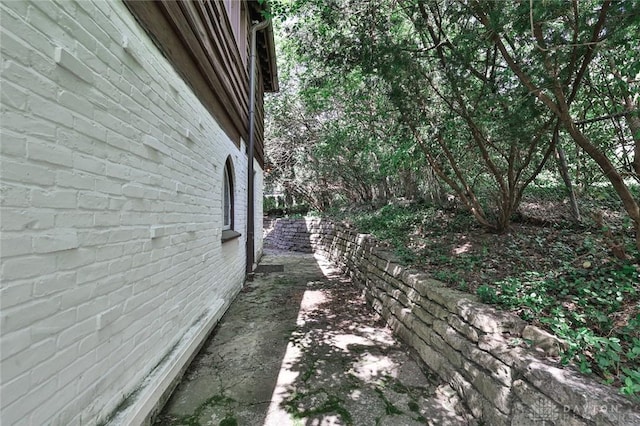 1515 Woodstock Dr, Oakwood, OH 45419 - view of property exterior featuring brick siding and a patio