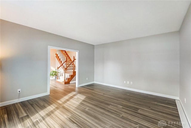 empty room with hardwood / wood-style flooring