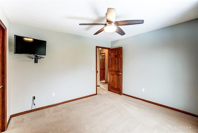 unfurnished bedroom with ceiling fan and light carpet