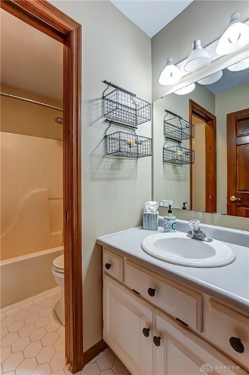 full bathroom with bathtub / shower combination, vanity, toilet, and tile patterned flooring