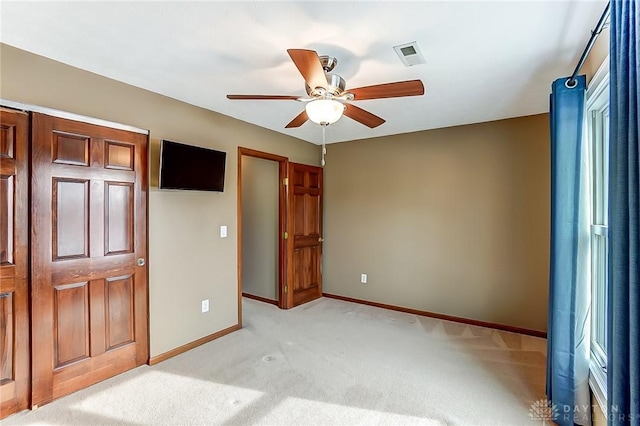 unfurnished bedroom featuring ceiling fan and light carpet