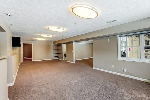 basement featuring carpet floors and a textured ceiling