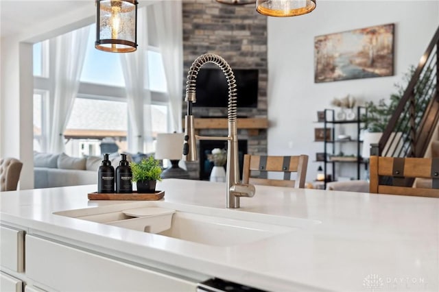 interior space featuring pendant lighting, light countertops, and a sink