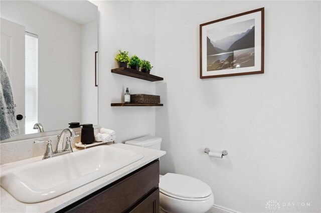 bathroom with toilet and vanity