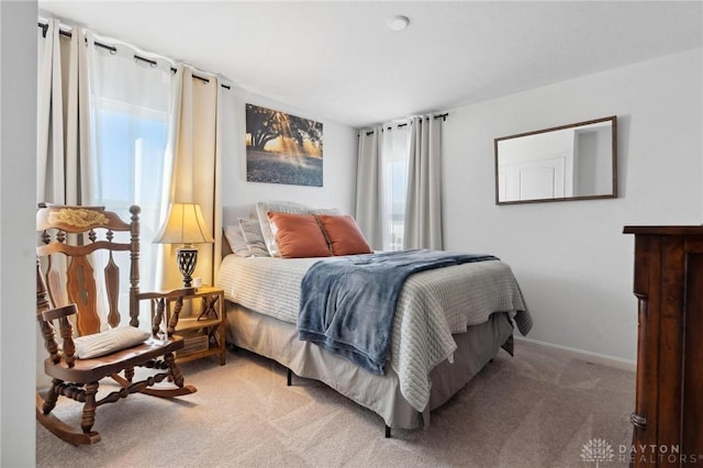 carpeted bedroom with baseboards