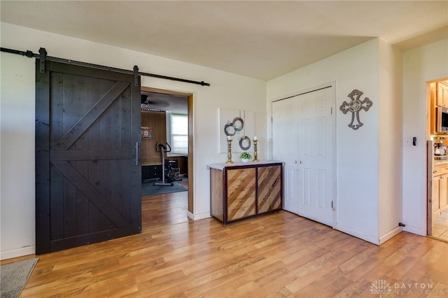 entrance foyer featuring a barn door and light hardwood / wood-style flooring