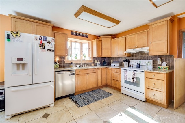 kitchen with tasteful backsplash, sink, light brown cabinets, and white appliances