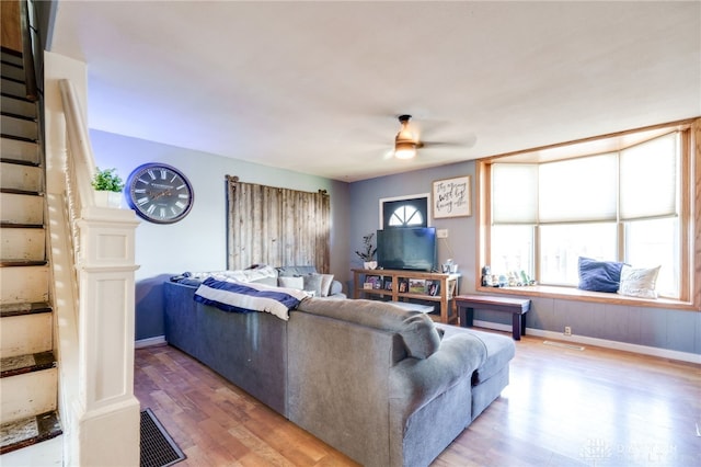 living room featuring ceiling fan and wood-type flooring