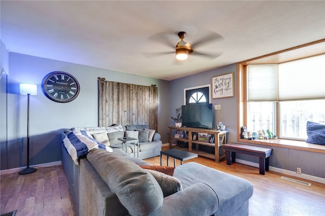 living room featuring ceiling fan and wood-type flooring