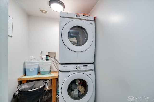 clothes washing area with stacked washer / drying machine