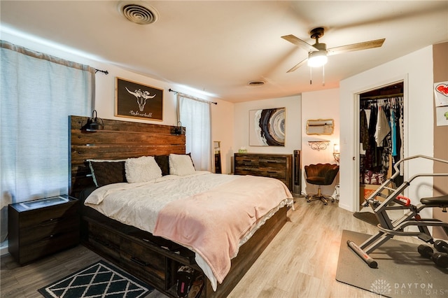 bedroom with ceiling fan and light hardwood / wood-style floors