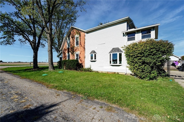 view of home's exterior with a yard