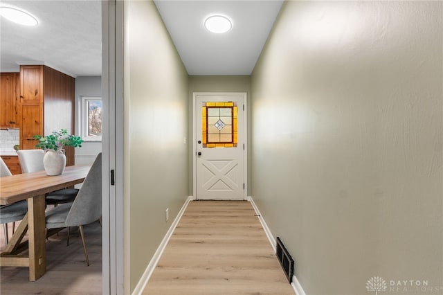 doorway to outside featuring light wood-type flooring