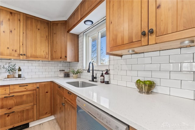 kitchen with tasteful backsplash, dishwasher, sink, and light stone counters