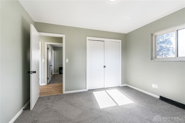 unfurnished bedroom with carpet floors and a closet