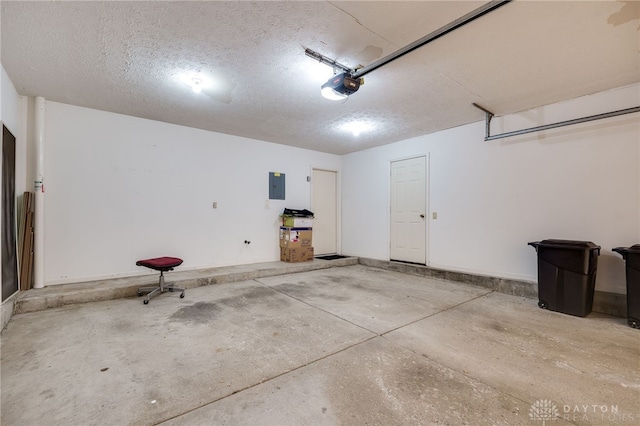 garage with a garage door opener and electric panel