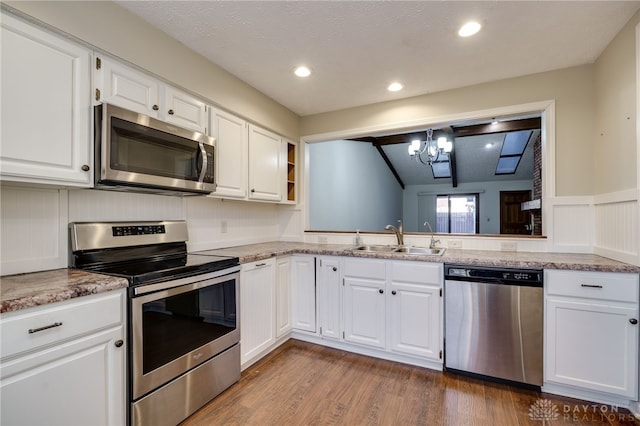 kitchen featuring white cabinetry, appliances with stainless steel finishes, dark hardwood / wood-style flooring, and sink