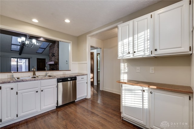 kitchen with dishwasher, sink, white cabinets, dark wood-type flooring, and an inviting chandelier