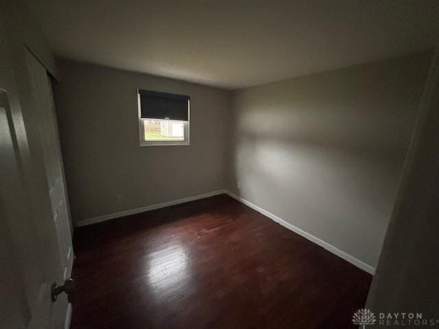 spare room featuring dark hardwood / wood-style floors