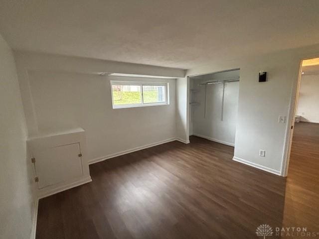 unfurnished bedroom featuring dark hardwood / wood-style floors and a closet