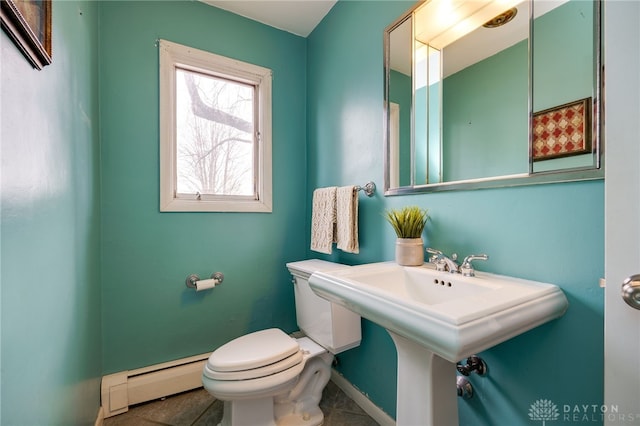 bathroom with a baseboard radiator and toilet