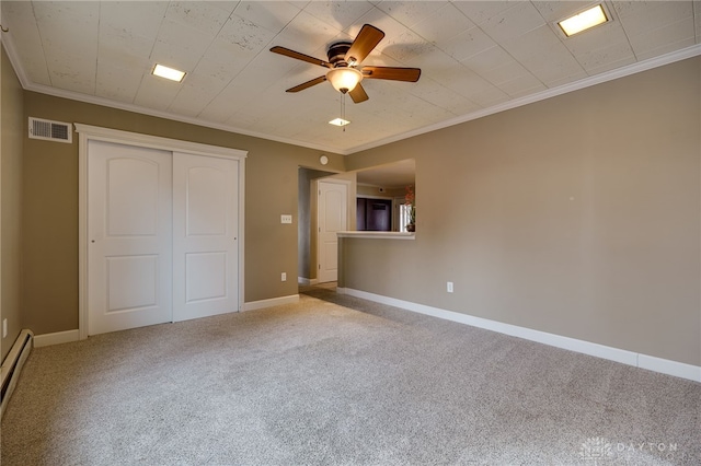 unfurnished bedroom featuring ceiling fan, baseboard heating, ornamental molding, light carpet, and a closet