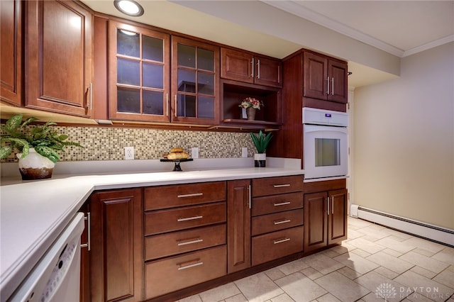 kitchen with ornamental molding, a baseboard heating unit, white appliances, and decorative backsplash