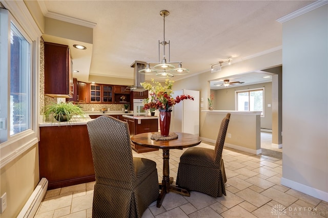 dining room featuring crown molding, a notable chandelier, and baseboard heating