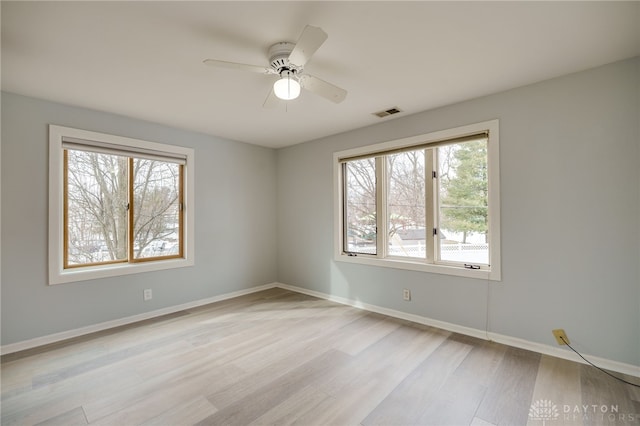 empty room with ceiling fan and light wood-type flooring