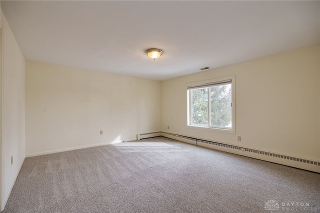 carpeted spare room with baseboard heating