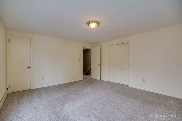 unfurnished bedroom with carpet and a closet