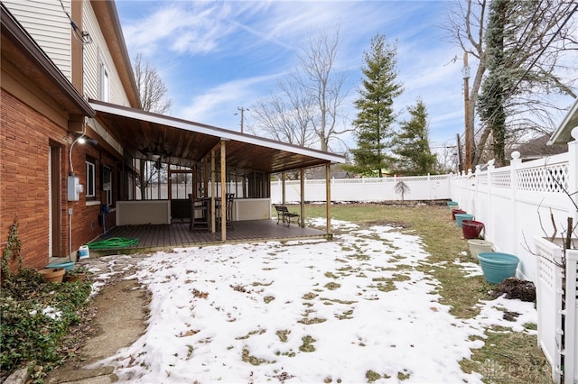 yard layered in snow featuring a wooden deck