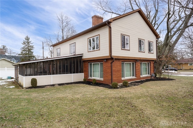 view of property exterior featuring a sunroom and a yard