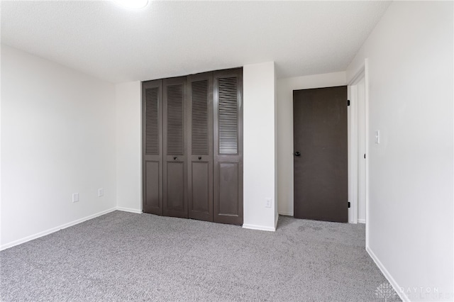 unfurnished bedroom featuring carpet floors and a closet