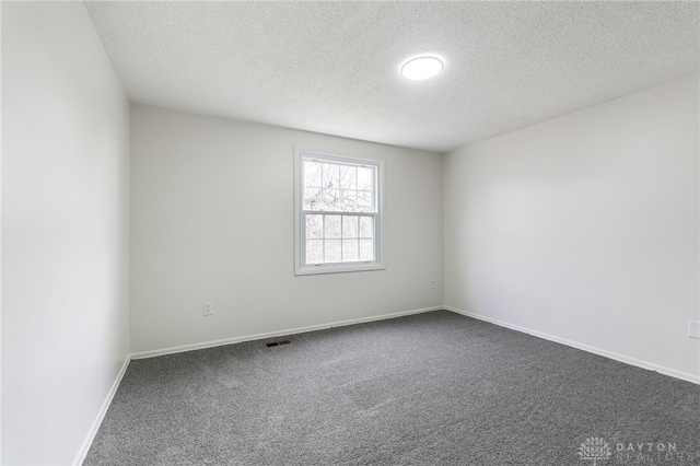 empty room featuring carpet floors and a textured ceiling