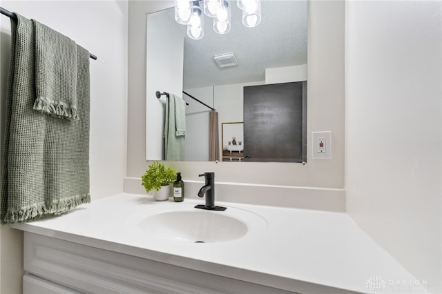 bathroom featuring vanity and a textured ceiling