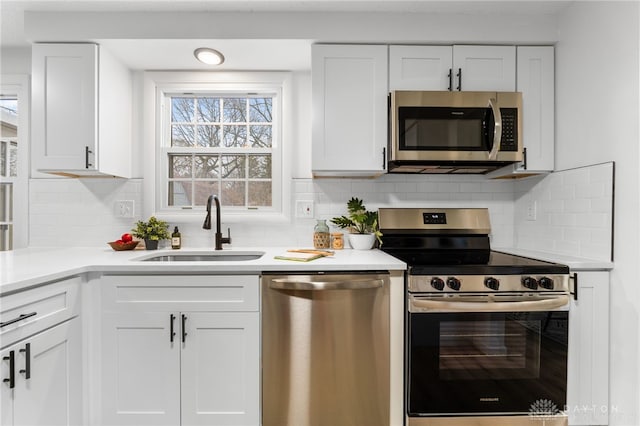 kitchen featuring white cabinetry, sink, tasteful backsplash, and appliances with stainless steel finishes