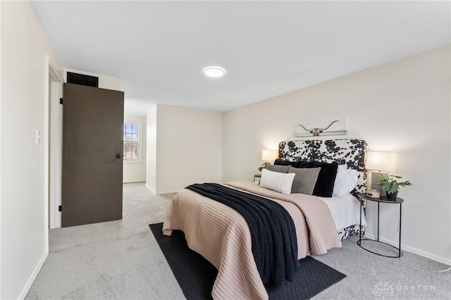 carpeted bedroom with a textured ceiling