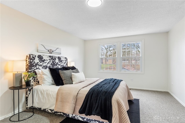 bedroom featuring a textured ceiling and carpet flooring