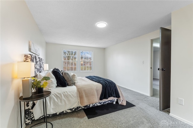 carpeted bedroom featuring a textured ceiling