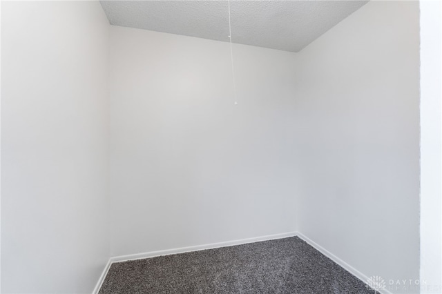 carpeted spare room featuring a textured ceiling